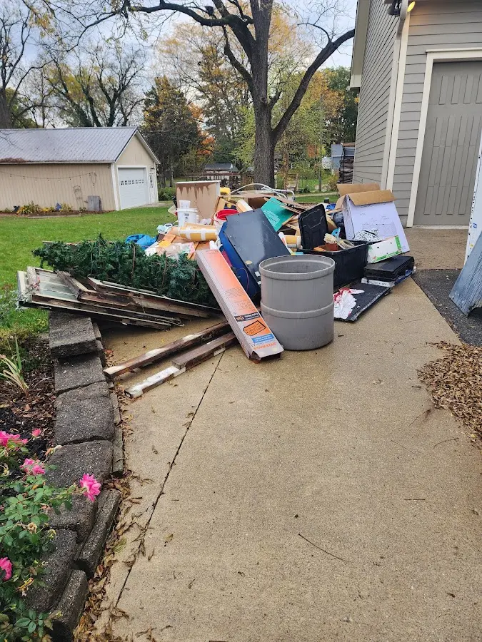Dumpster being loaded with debris for Roofing Dumpster Rental in Richlands